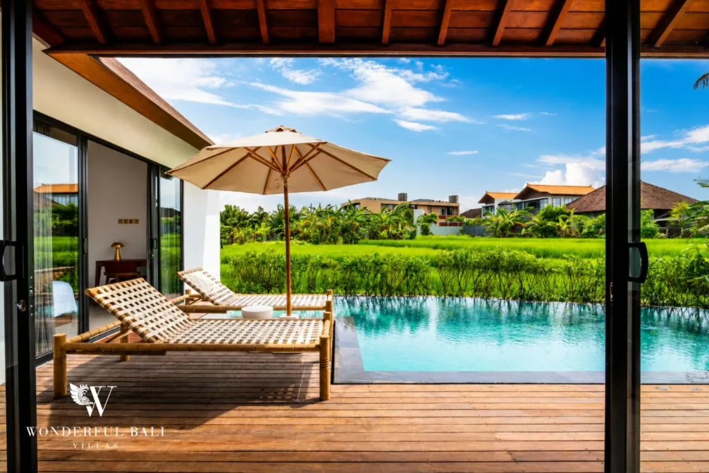 3BR villa for monthly rent Canggu — living area with pool and rice field view