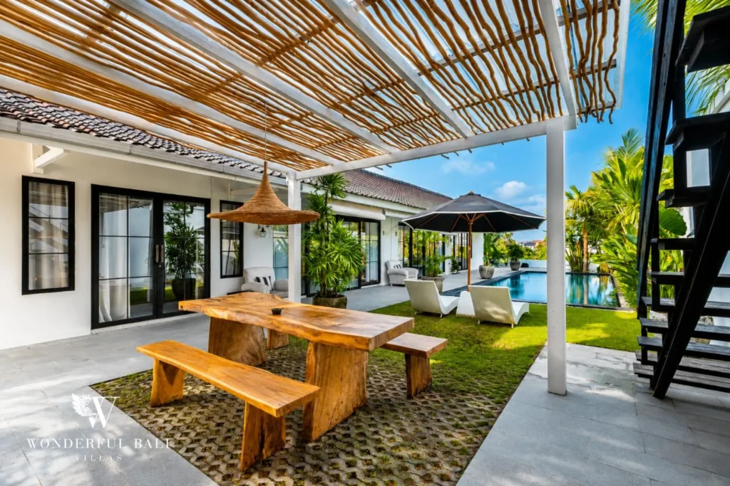 Outdoor dining table under a bamboo pergola in the garden at villa in Canggu, Bali