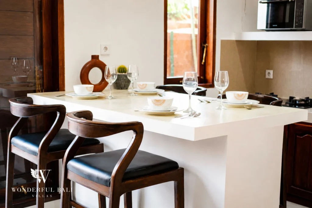 Dining bar detail with timber stools and ceramic accents in Nyanyi, Bali
