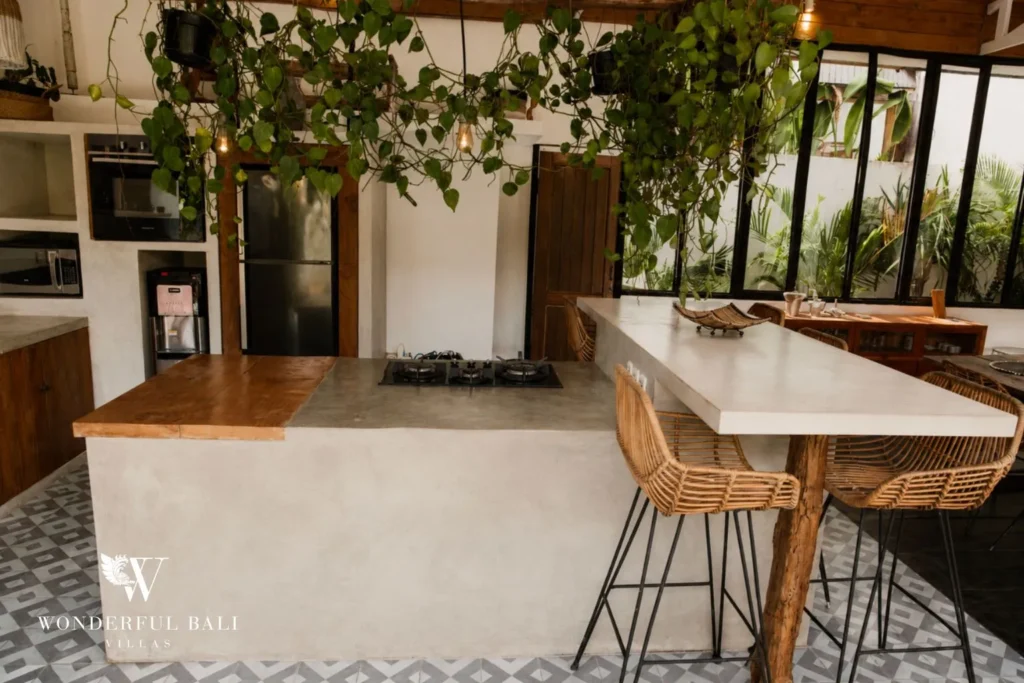 Dining nook with rattan chairs and patterned tile floor at villa in Canggu, Bali