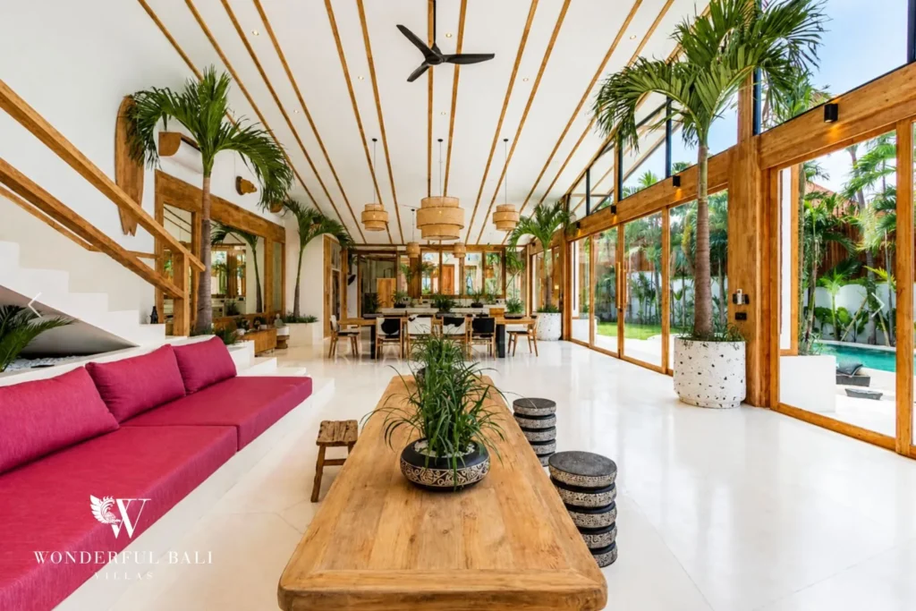 Open-plan living room with magenta sofa and vaulted ceiling at family villa in Umalas, Bali