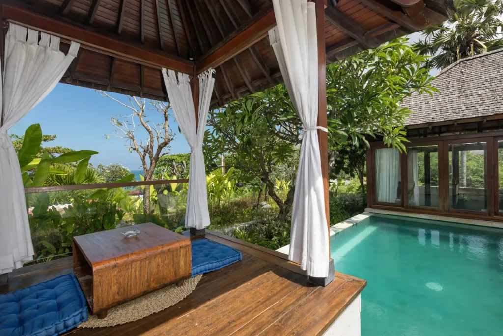 Pool with private curtained bale and loungers at villa in Batu Belig, Bali