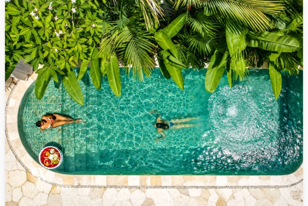 Pool surrounded by lush jungle planting at villa in Umalas, Bali