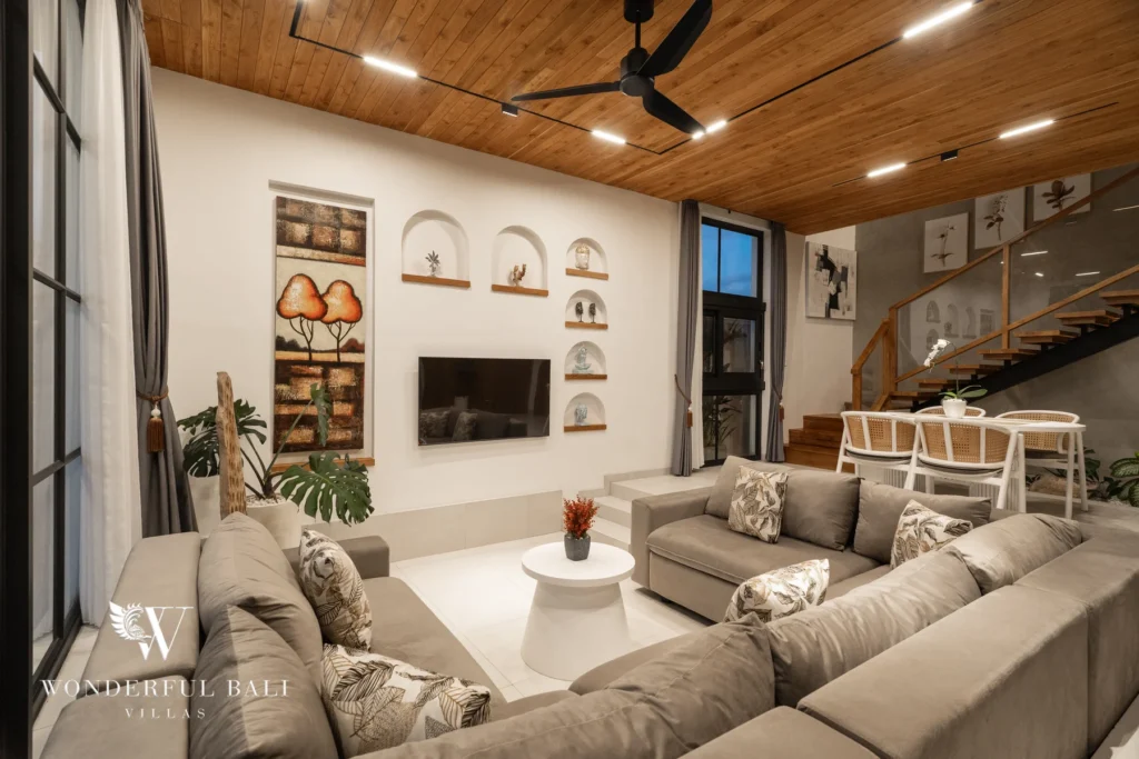 Living lounge with L-shaped sofa and arched niches at villa in Umalas, Bali