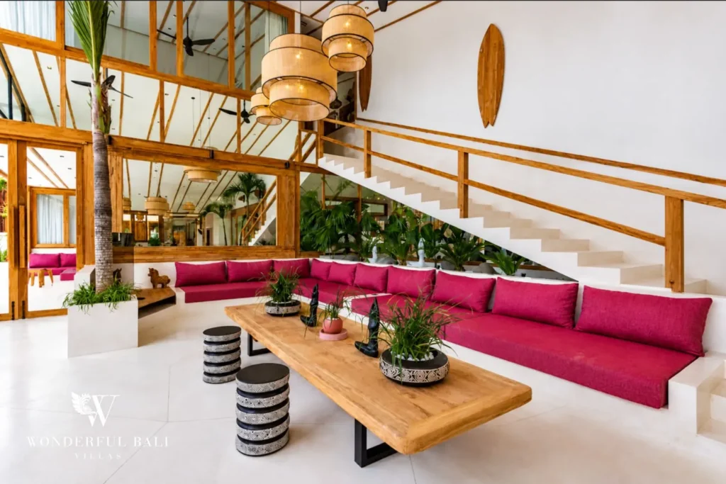 Living lounge with pink sofa and pool view at family villa in Umalas, Bali