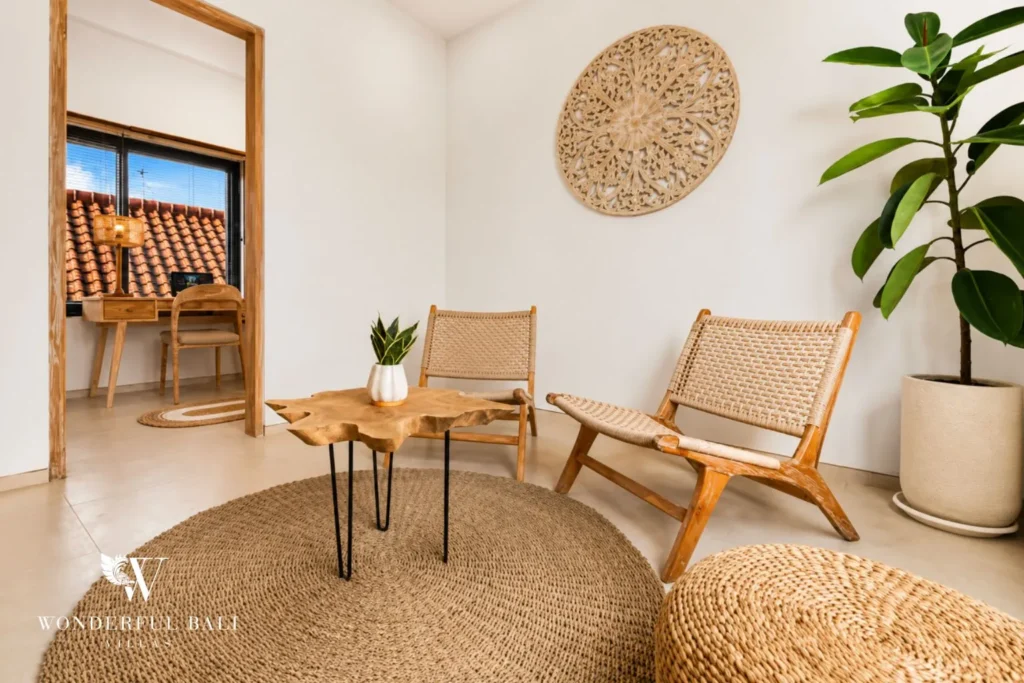 Lounge with rattan chairs, round table and potted plant at villa in Canggu, Bali