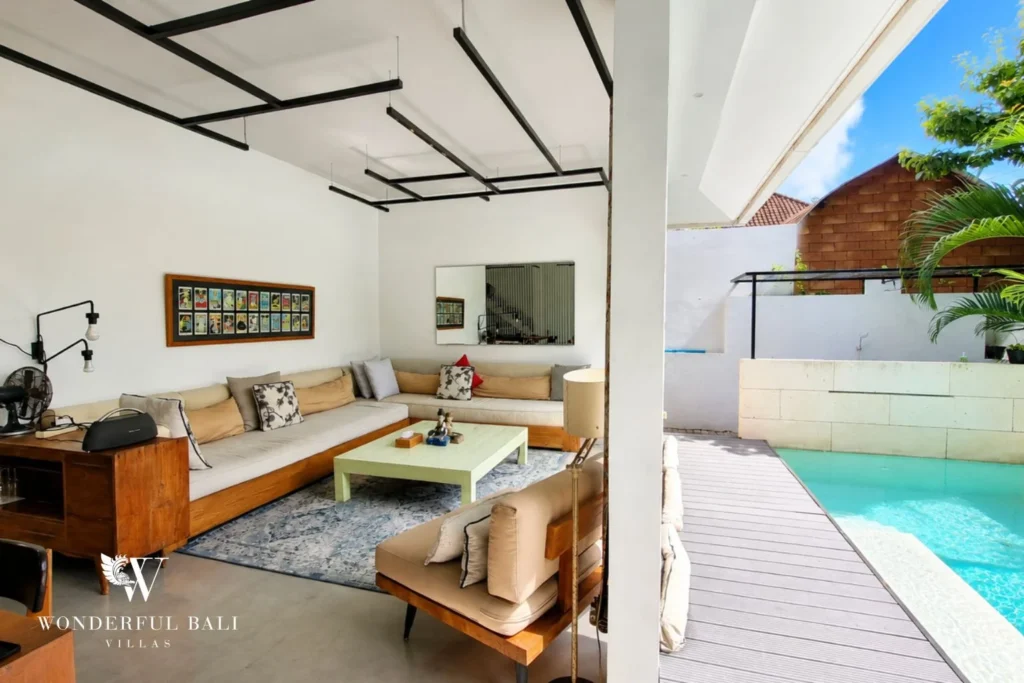 Lounge area with beige sofas and gallery-wall art at villa in Umalas, Bali
