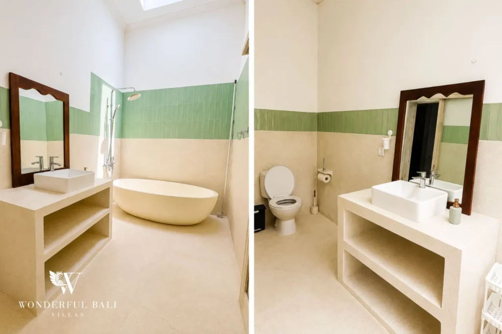 Bathroom with timber vanity, mirror and green accent wall at villa in Canggu, Bali