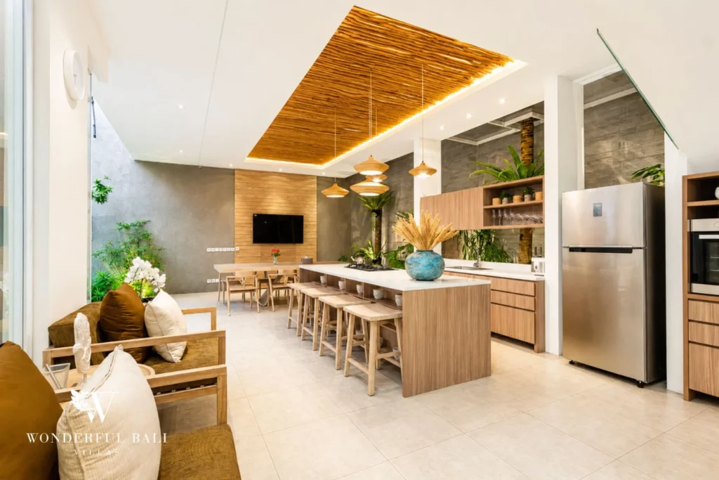 Open kitchen and dining table opening directly onto the pool deck at villa in Petitenget, Bali