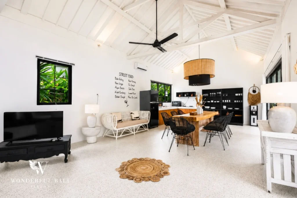 Open-plan living area with TV under a high white ceiling at villa in Canggu, Bali