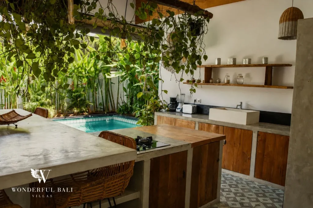 Outdoor kitchen with stone counter and tropical plants at villa in Canggu, Bali