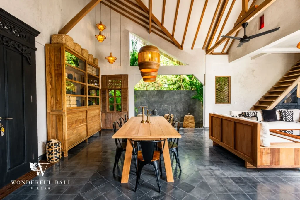 Wooden dining table in open living area at a villa in Canggu, Bali