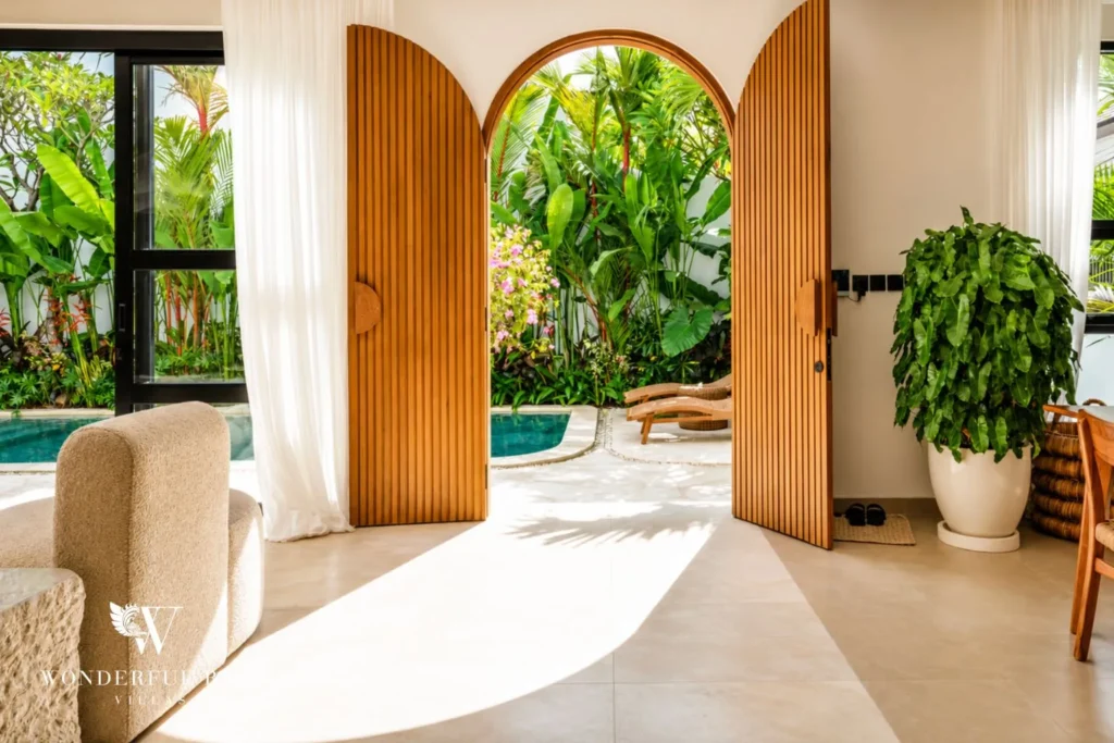Arched doorway opening to the pool and garden at villa in Umalas, Bali