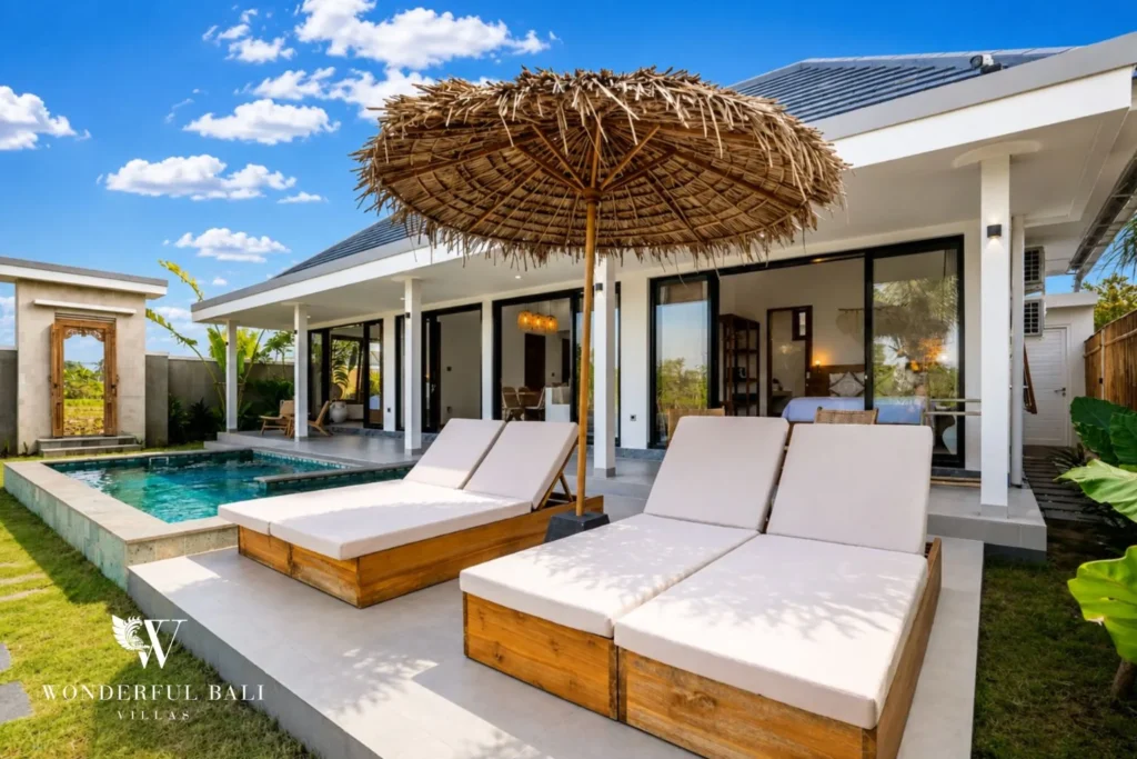 Bedroom opening to the pool and garden at villa in Ubud, Bali