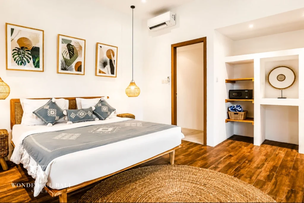 Bedroom with framed art and walk-in wardrobe at villa in Umalas, Bali