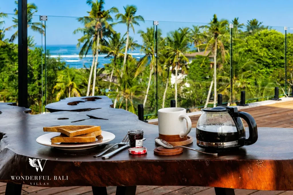 Dining area and kitchen at a 4-bedroom ocean-view villa in Seseh, Bali