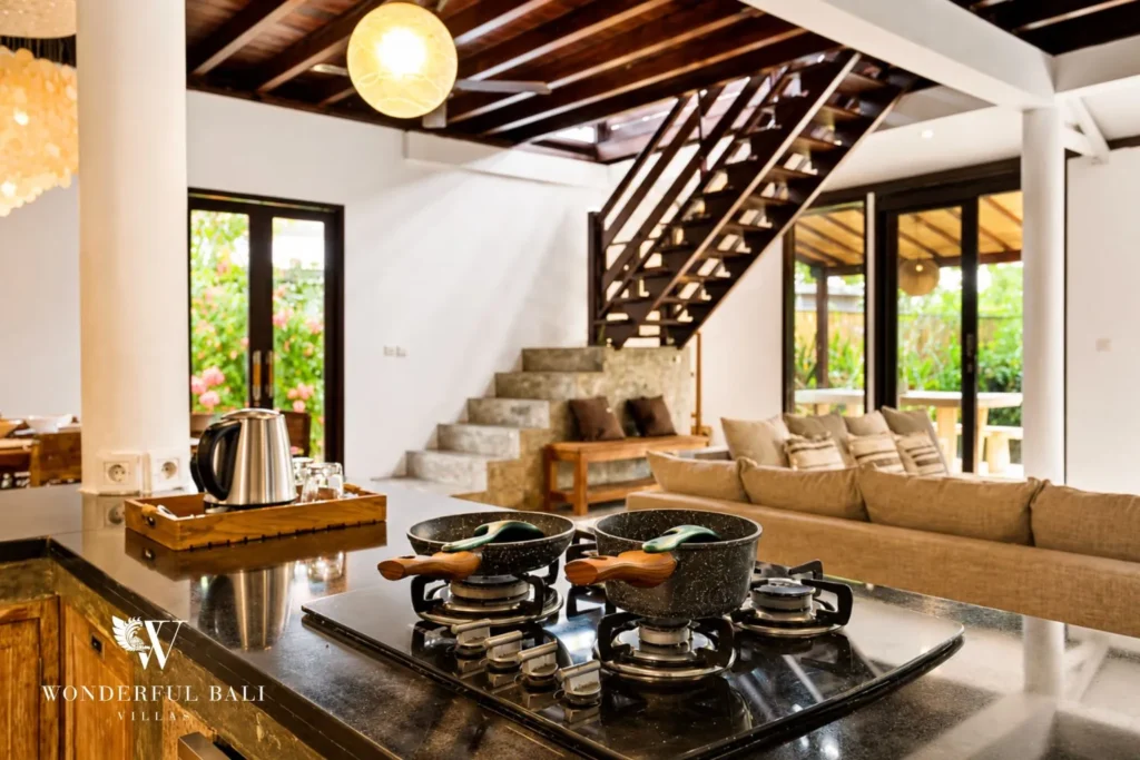 Open-plan living and dining with sofas and stepped layout at villa in Umalas, Bali