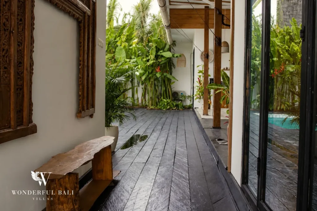 Outdoor walkway on a timber deck framed by plants at villa in Canggu, Bali