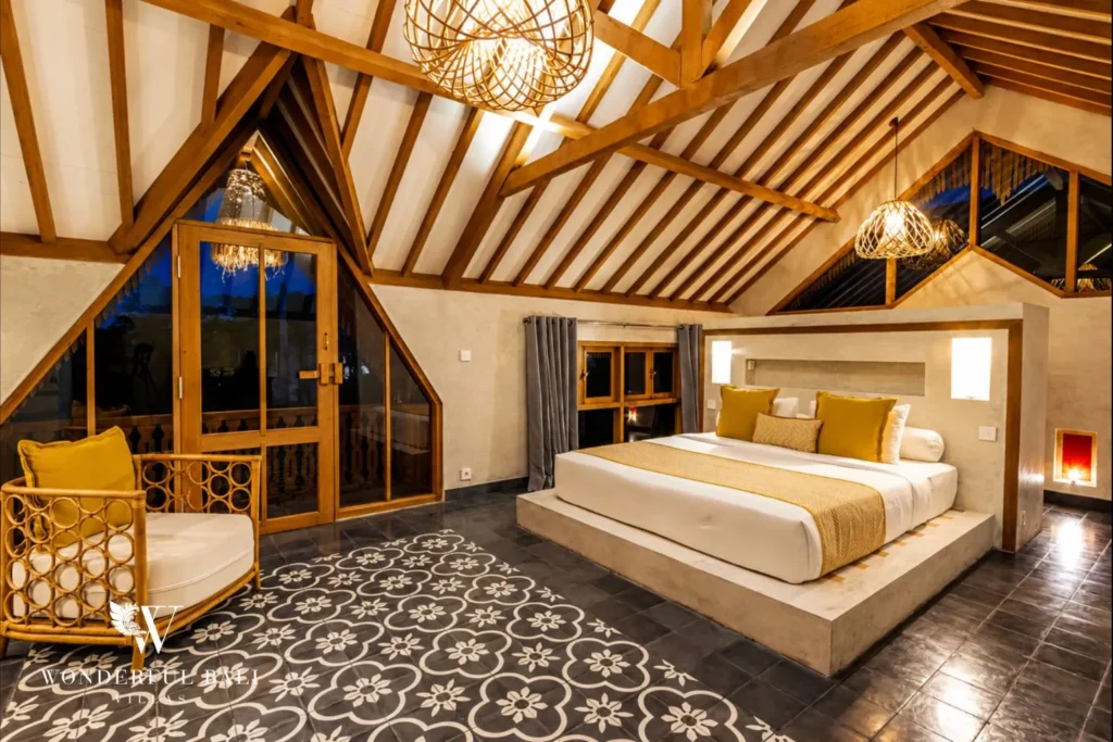 Bedroom with rattan chairs and vaulted ceiling at a villa in Canggu, Bali