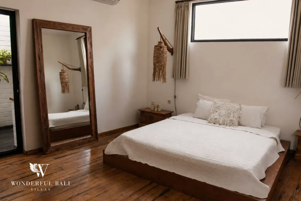 Bedroom with white bed, standing mirror and window at villa in Canggu, Bali