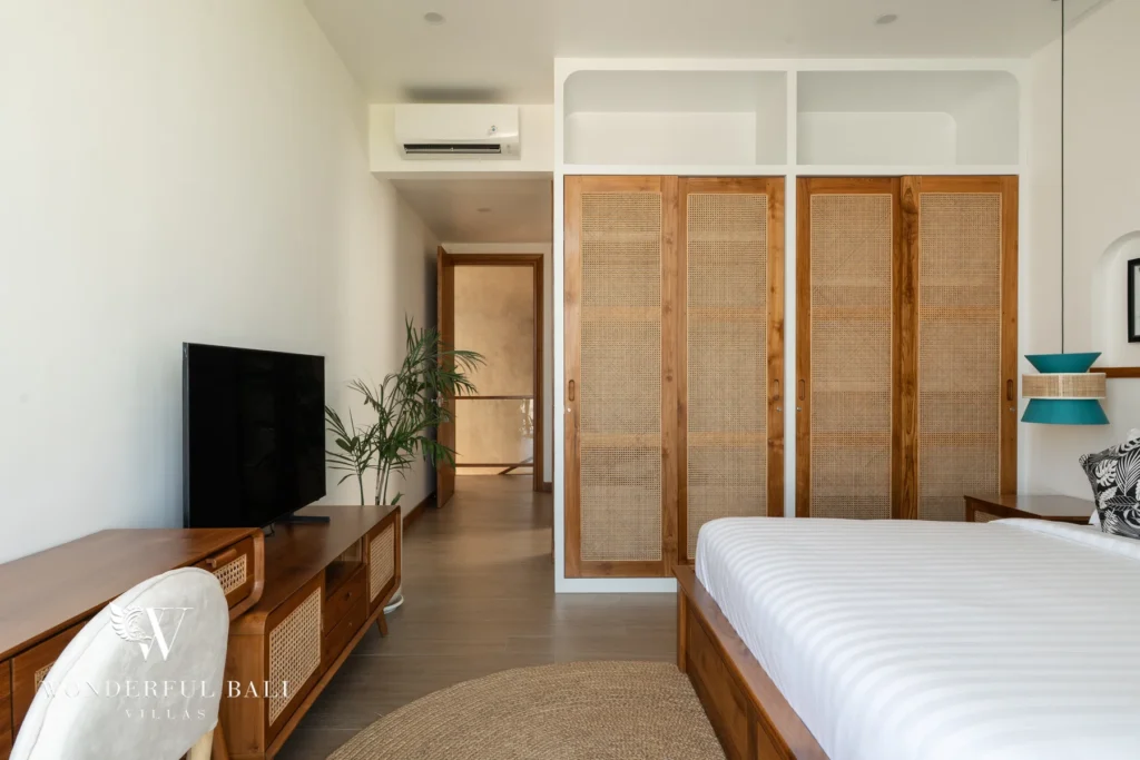 Bedroom with woven screen and timber console at villa in Umalas, Bali