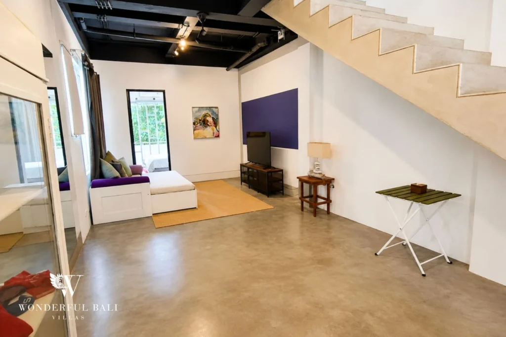 Daybed lounge with purple accent wall and contemporary art at villa in Umalas, Bali