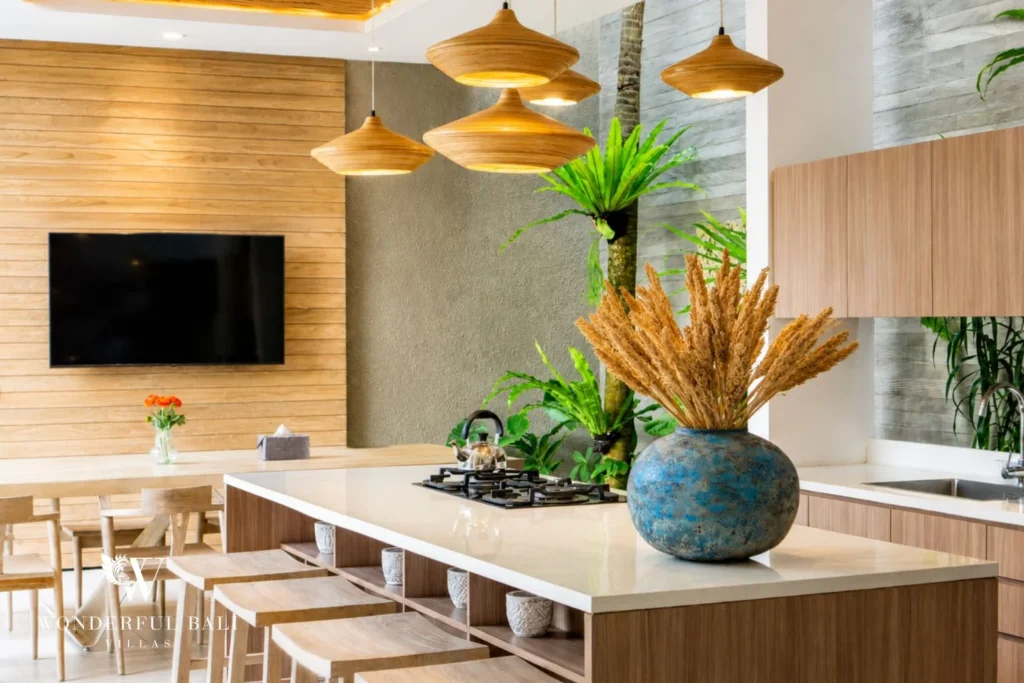 Open kitchen and dining area with TV at villa in Petitenget, Bali