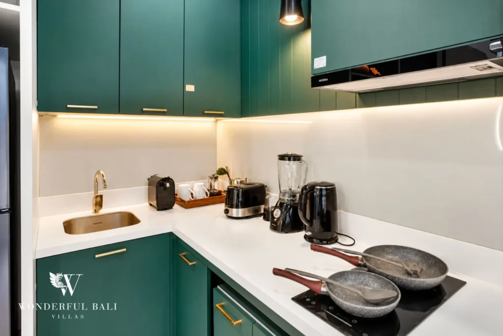 Kitchen detail with green cabinetry and timber counters at villa in Denpasar, Bali