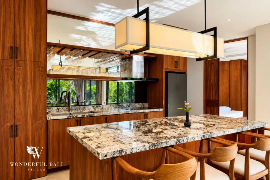 Kitchen with marble island and bar stools at villa in Umalas, Bali