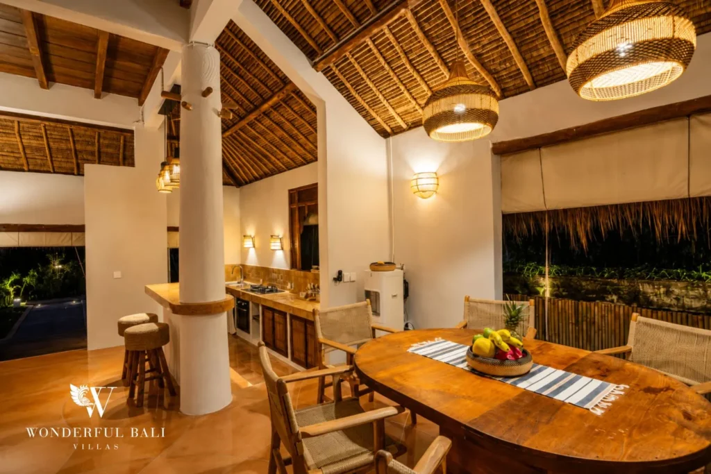 Living lounge with bar counter and terracotta-tiled floor at villa in Bumbak, Bali