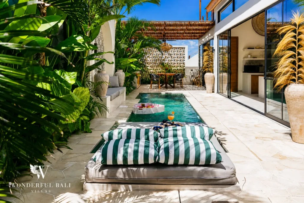 Pool with striped lounger and garden walkway at villa in Seseh, Bali