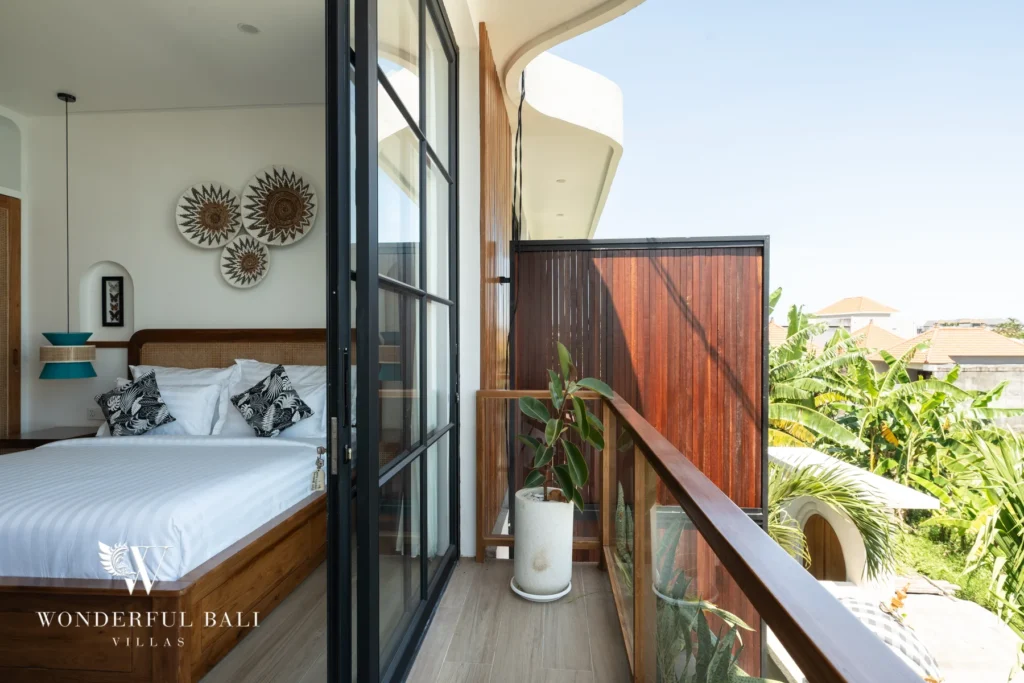 Bedroom with black-framed glass doors to a balcony at villa in Umalas, Bali