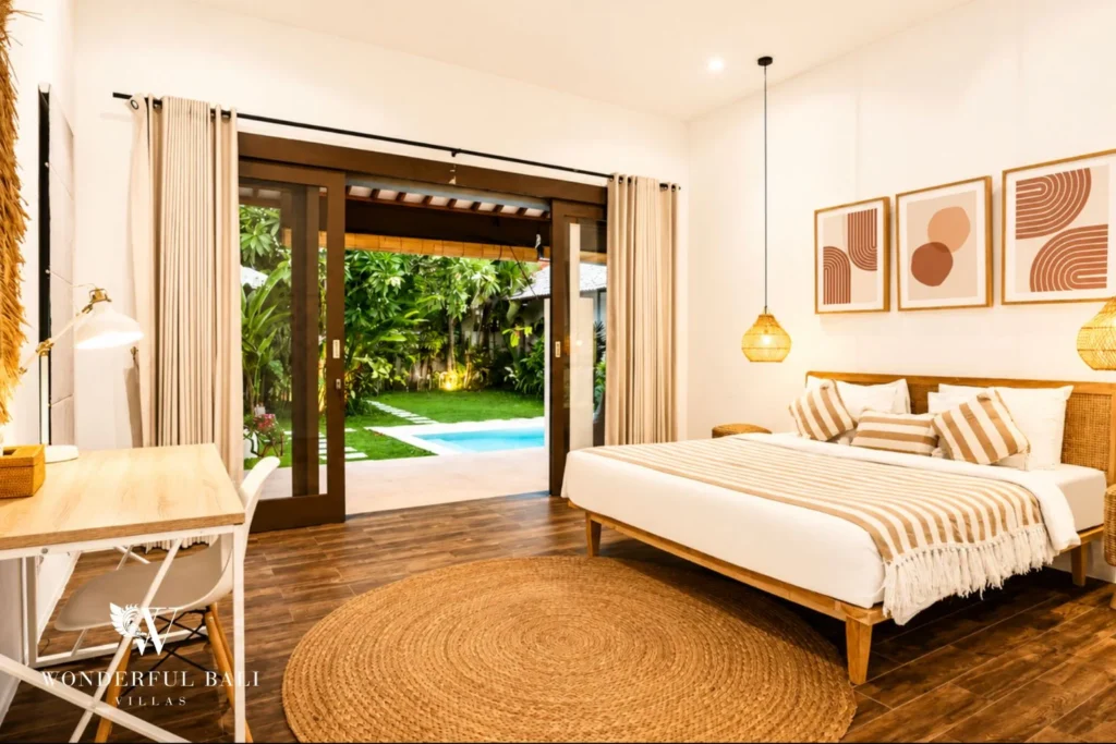 Bedroom with desk and sliding doors opening to the pool at villa in Umalas, Bali