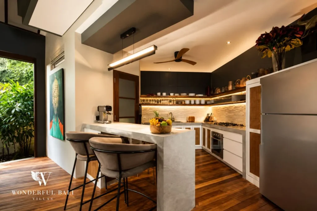 Kitchen island with bar stools in open-plan space at villa in Umalas, Bali