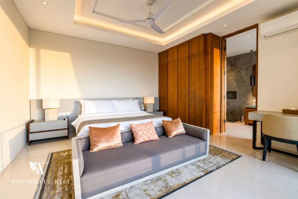 Living and media room with grey sofas and rug at villa in Umalas, Bali