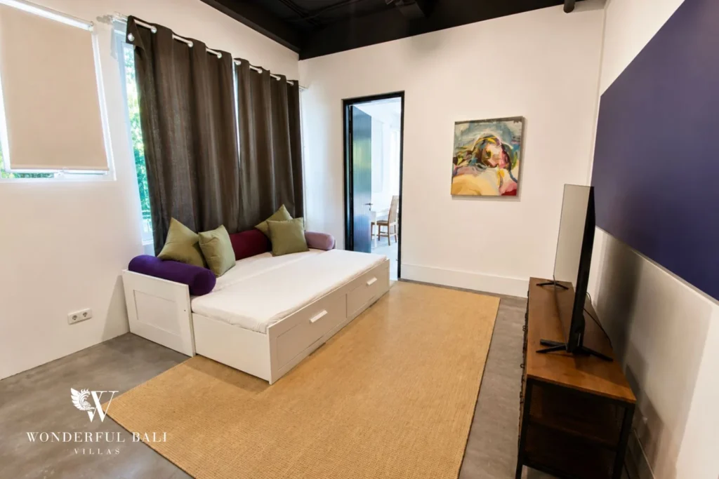 Daybed lounge with view to adjoining bedroom at villa in Umalas, Bali