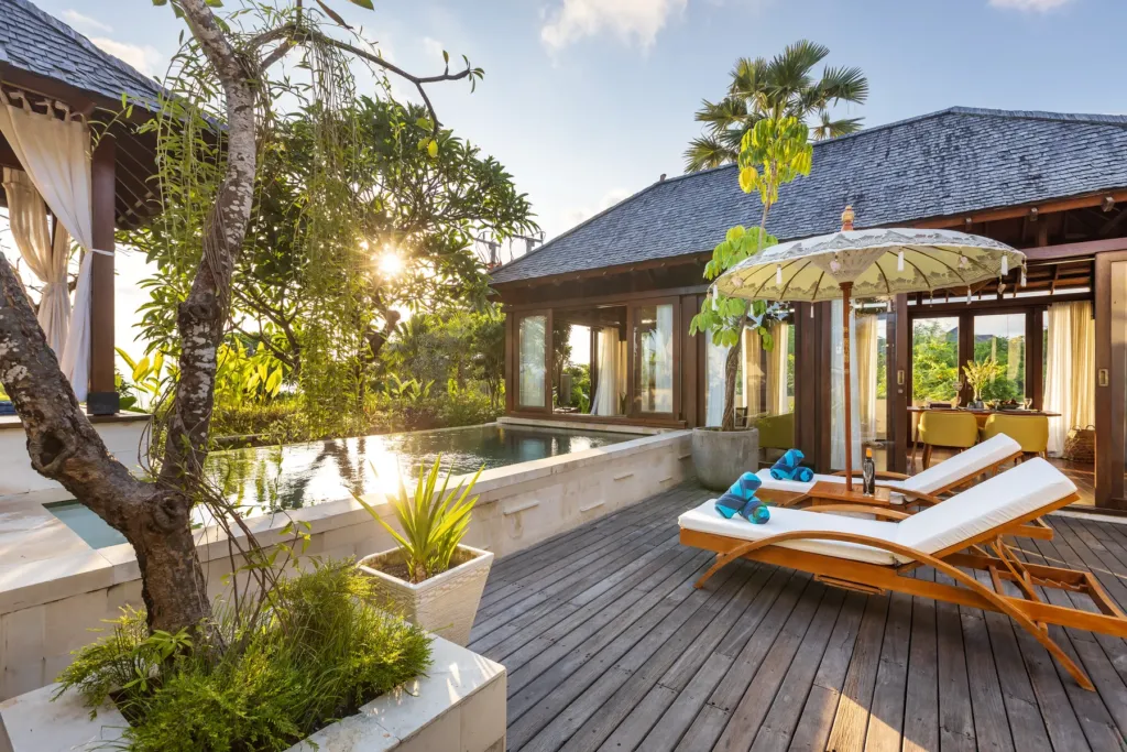 Thatched bale with daybed at sunset at villa in Batu Belig, Bali