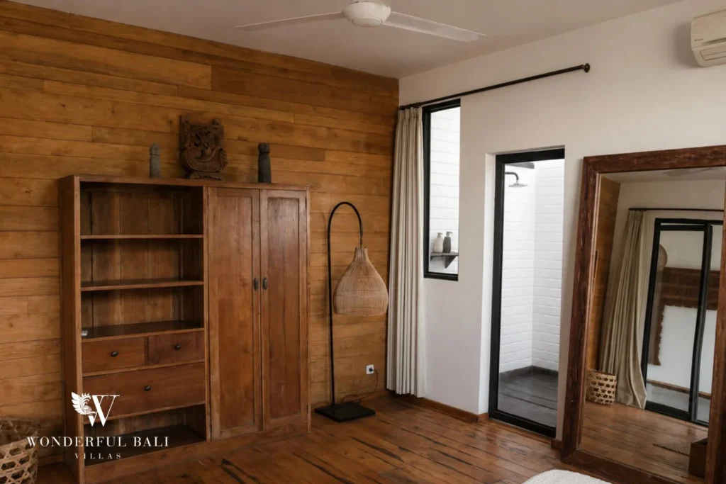 Dressing area with timber wardrobe cabinet and mirror at villa in Canggu, Bali