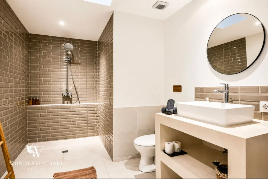 En-suite bathroom with walk-in rain shower and stone vanity at villa in Umalas, Bali