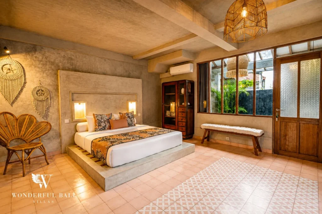 Bedroom with platform bed and terracotta tile floor at a villa in Canggu, Bali