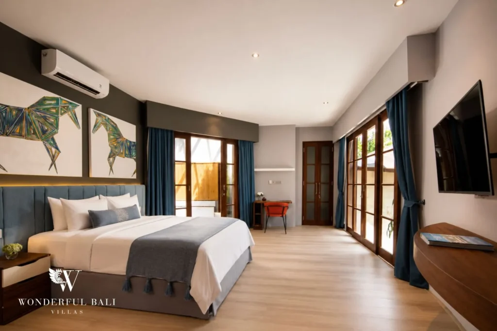 Bedroom with white bed and glass doors to the garden at villa in Umalas, Bali