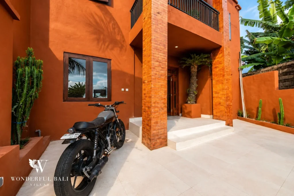 Entrance courtyard with motorbike and terracotta pillars in Nyanyi, Bali