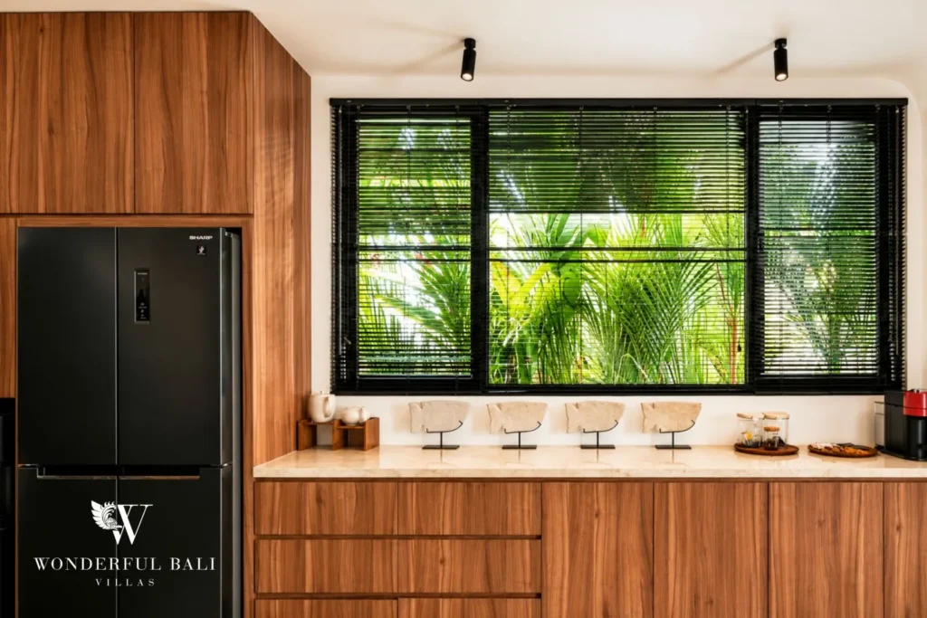 Kitchen detail with timber cabinetry and window at villa in Umalas, Bali