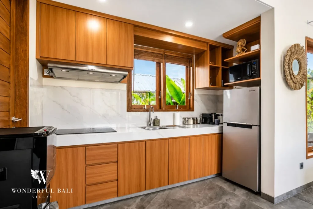 Kitchen with timber cabinets and marble counter at villa in Ubud, Bali