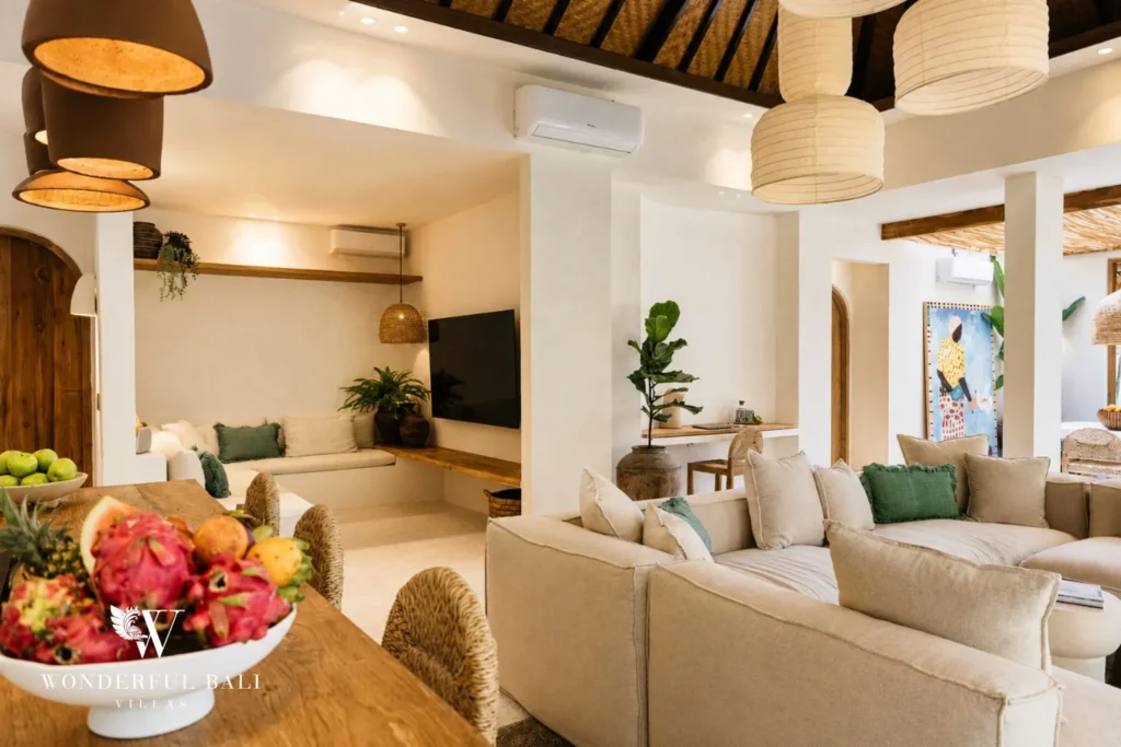Living area with sofa, TV and arched doorway at villa in Berawa, Bali
