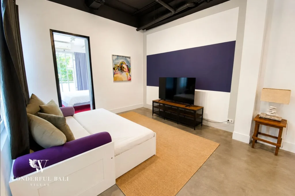 Master bedroom with timber feature wall, king bed and work desk at villa in Umalas, Bali