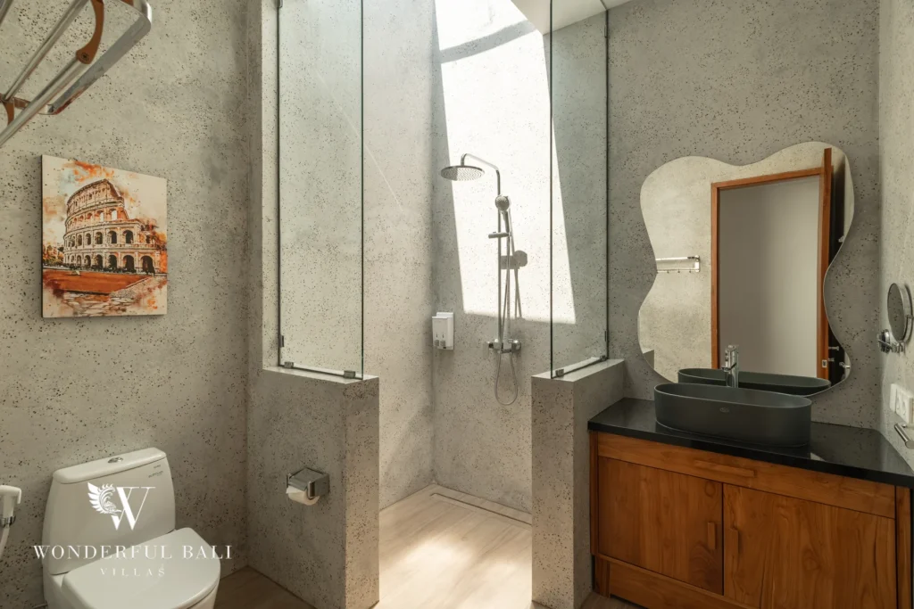 Bathroom with concrete finish and double vanity at villa in Umalas, Bali