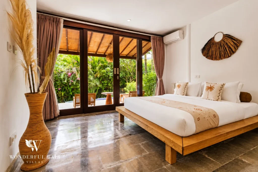 Bedroom with king bed, glass doors to garden and timber ceiling at villa in Umalas, Bali