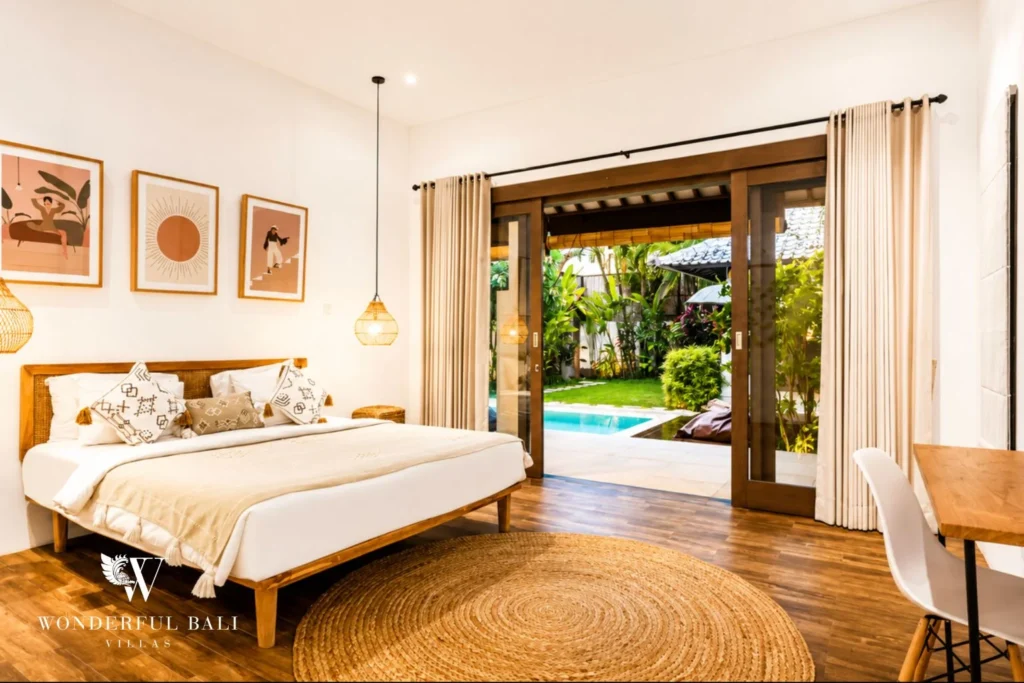 Bedroom with sliding doors opening to the pool and garden at villa in Umalas, Bali