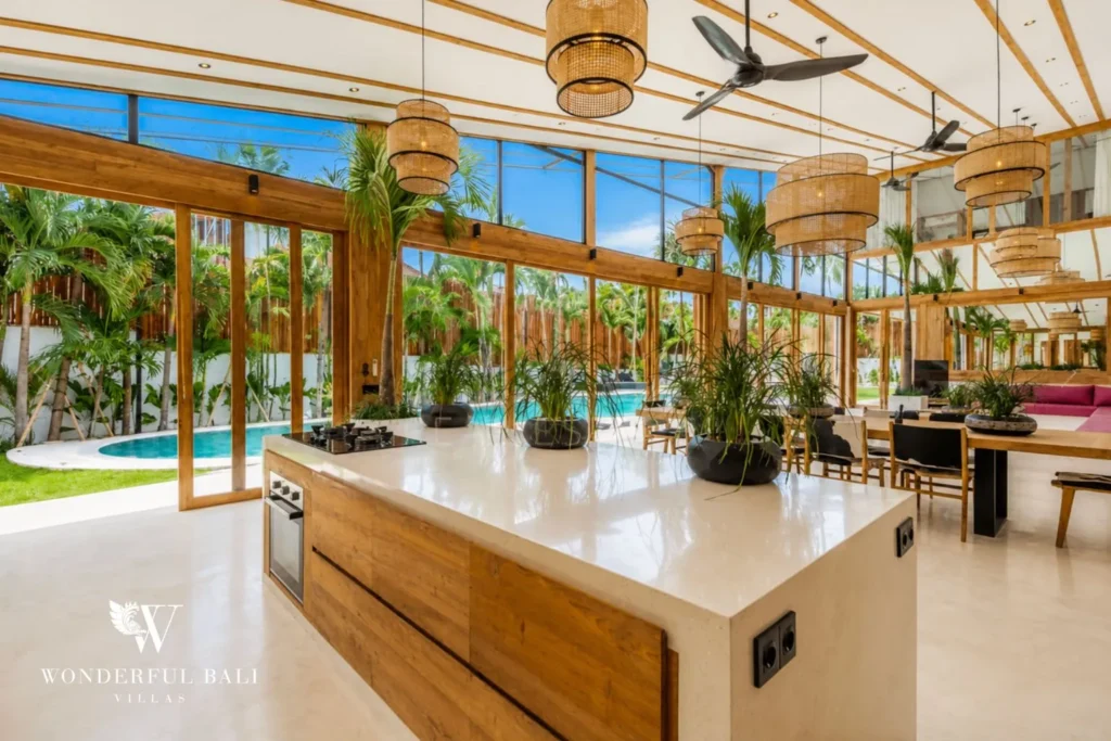 Marble kitchen island with open-plan dining at family villa in Umalas, Bali